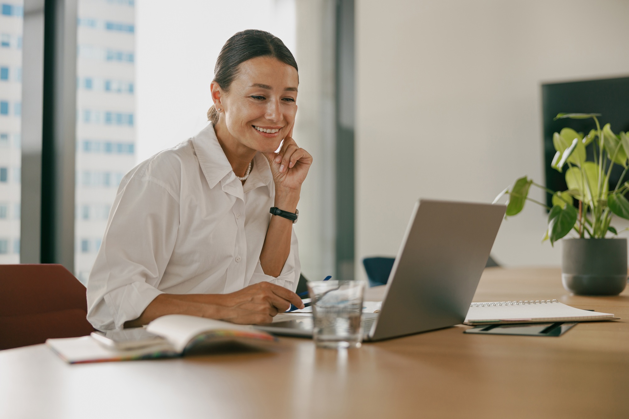 A Professional Woman is in a Modern Workspace