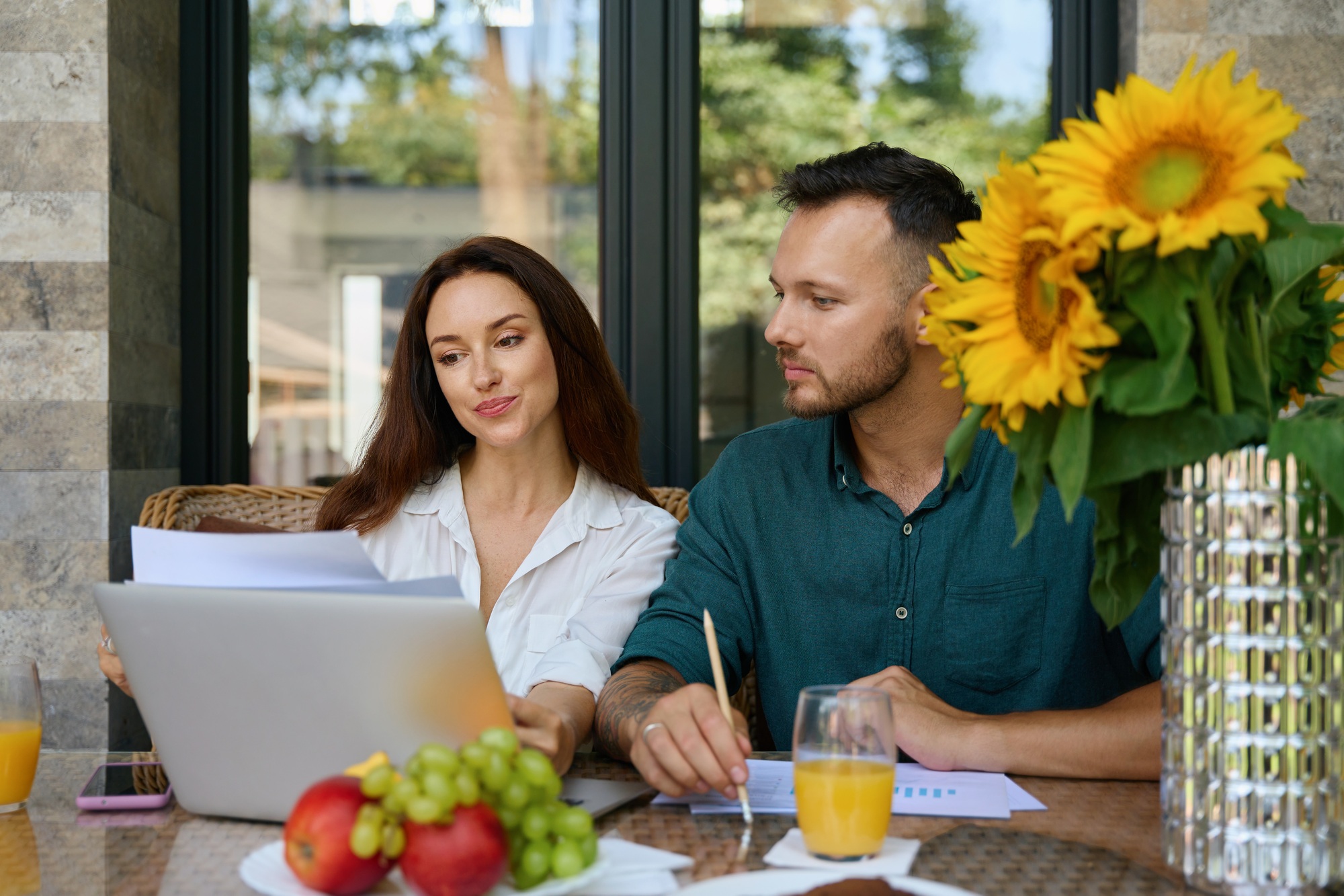 Spouses work with documents on the terrace