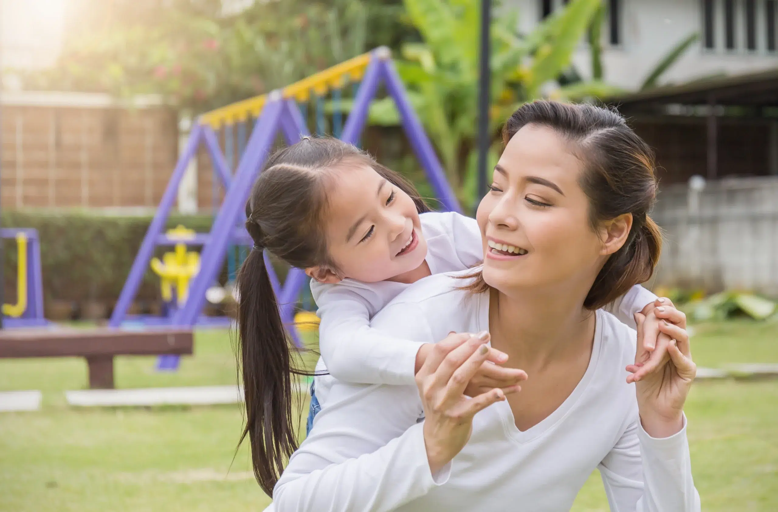 woman and toddler playing in the backyard