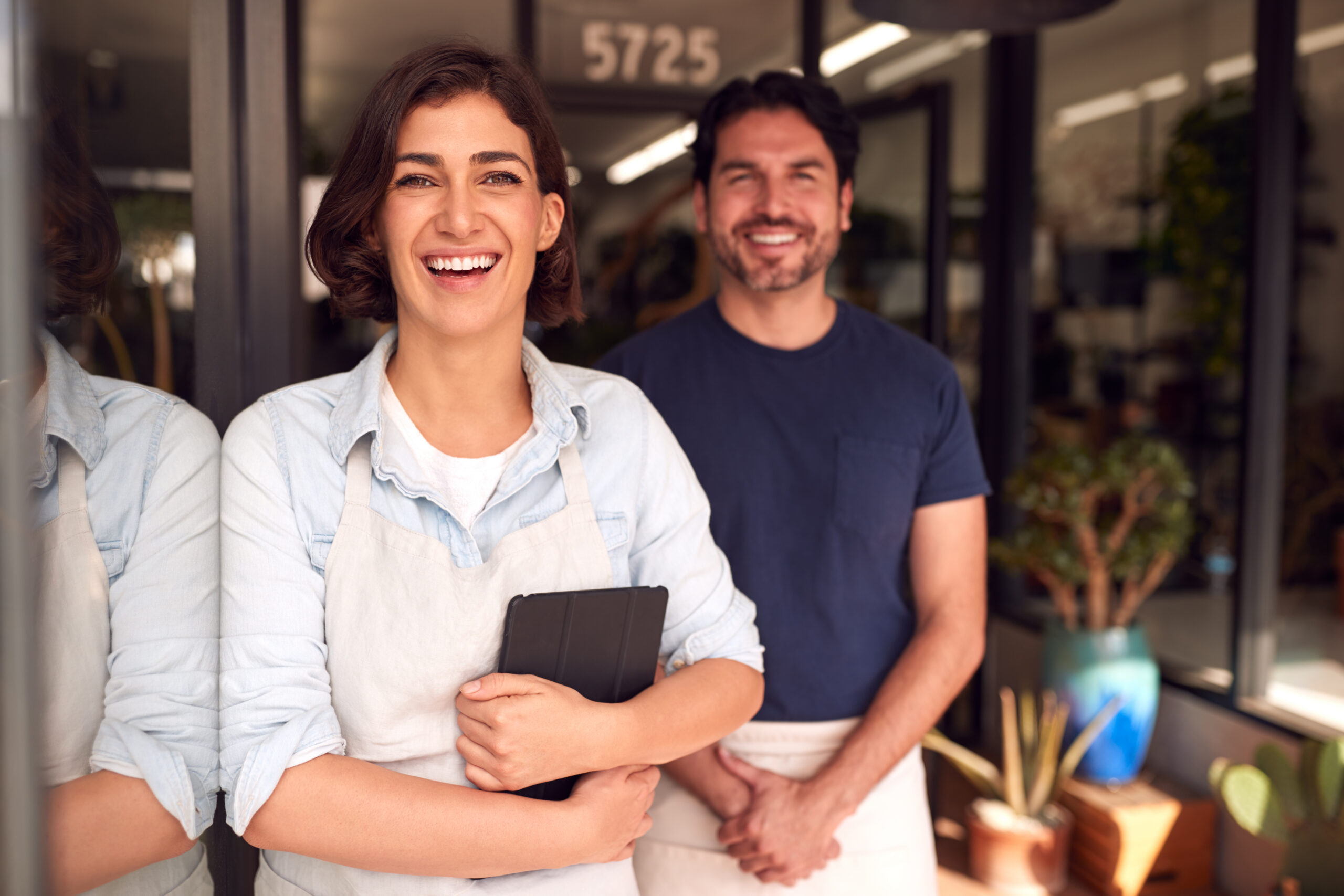 Philadelphia High Asset Divorce Lawyers: Navigating Complex Divorces with Confidence 36 Portrait Of Male And Female Owners Of Florists With Digital Tablet Standing In Doorway With Plants